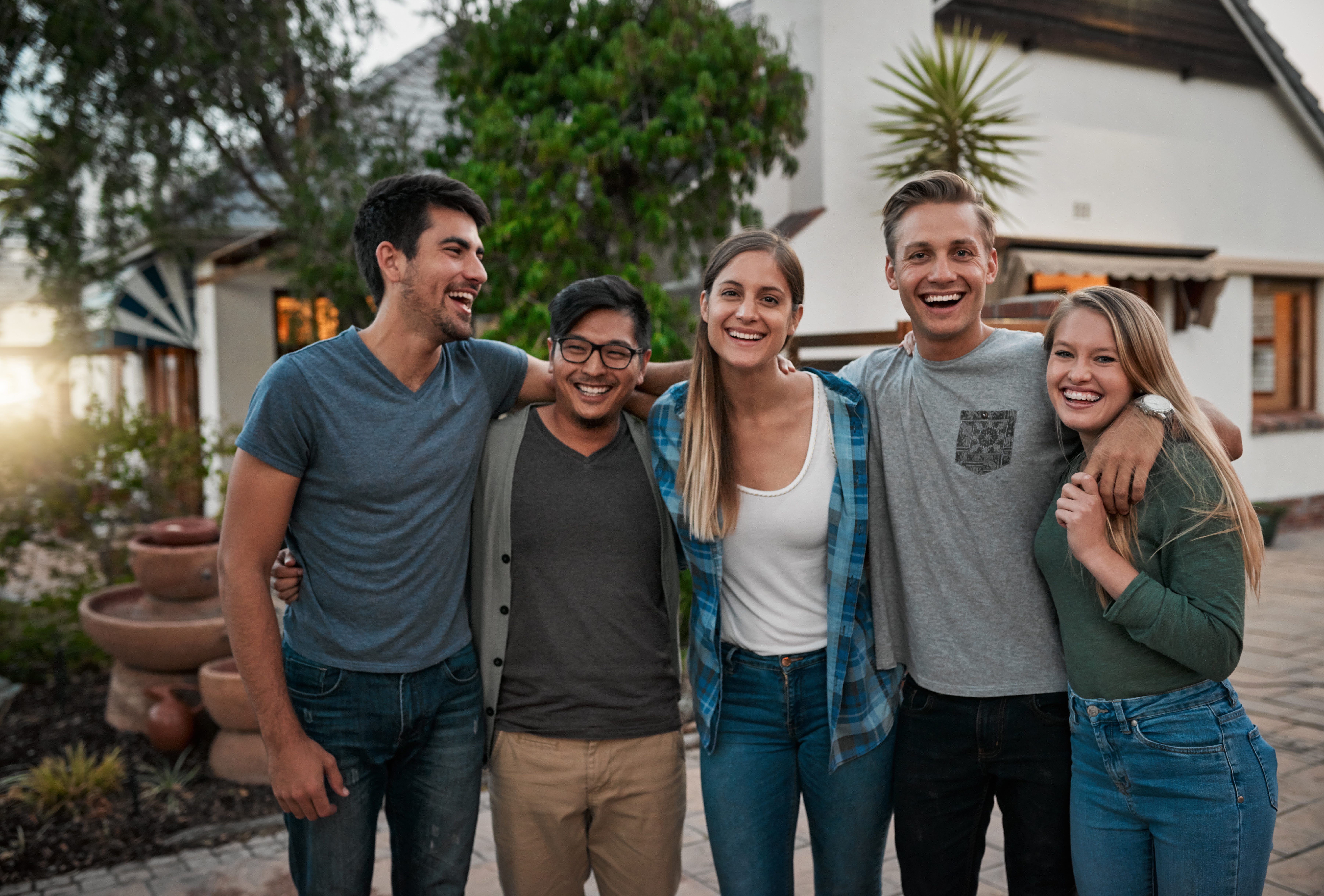 Friends laughing together outdoors near a South Florida home